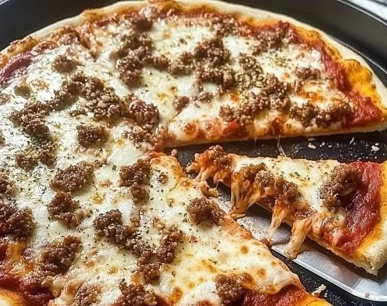 Slice of amazing lasagna pizza topped with cheese and herbs