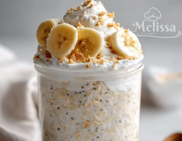 Delicious banana cream pie overnight oats topped with sliced bananas and whipped cream.