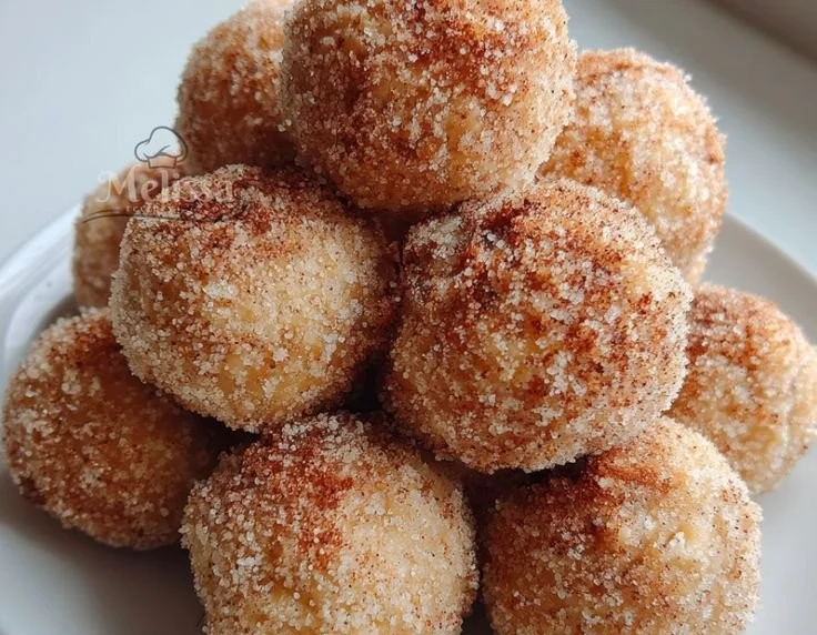 Freshly made Banana Donut Holes dusted with powdered sugar