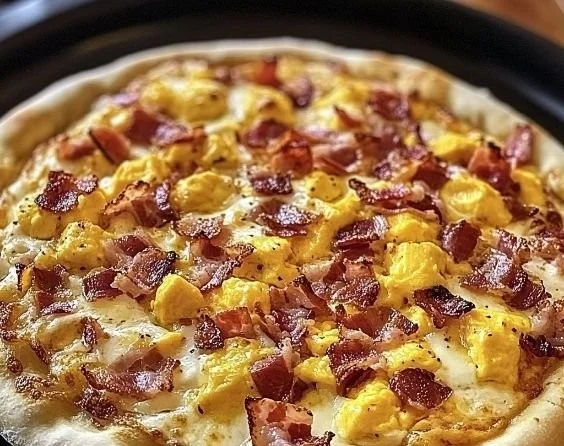 Delicious breakfast pizza topped with eggs, cheese, and vegetables