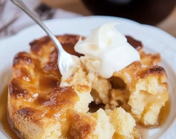Delicious homemade brioche bread pudding served warm with a caramel drizzle.