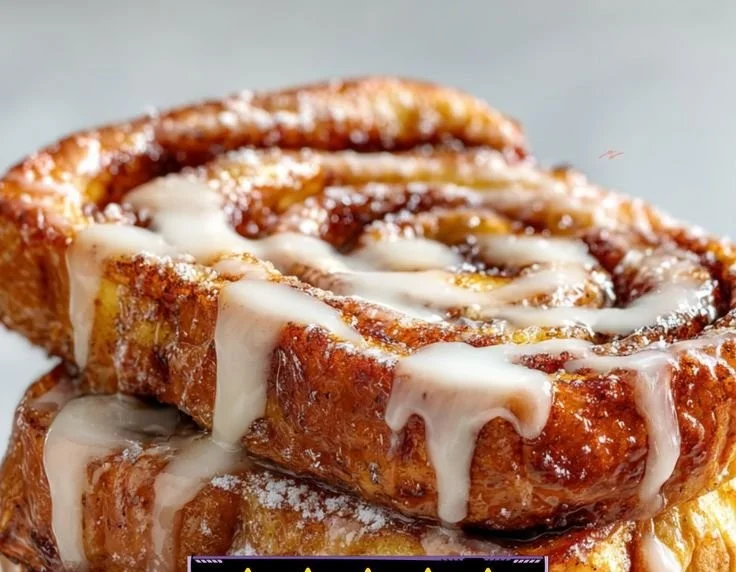 Delicious Cinnamon Roll French Toast topped with icing and berries