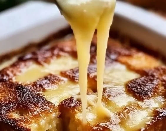 Classic New Orleans bread pudding with rich sauce and garnished with cinnamon