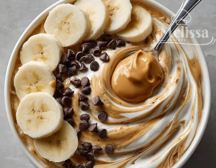 A delicious Peanut Butter Yogurt Bowl topped with fruits and granola.