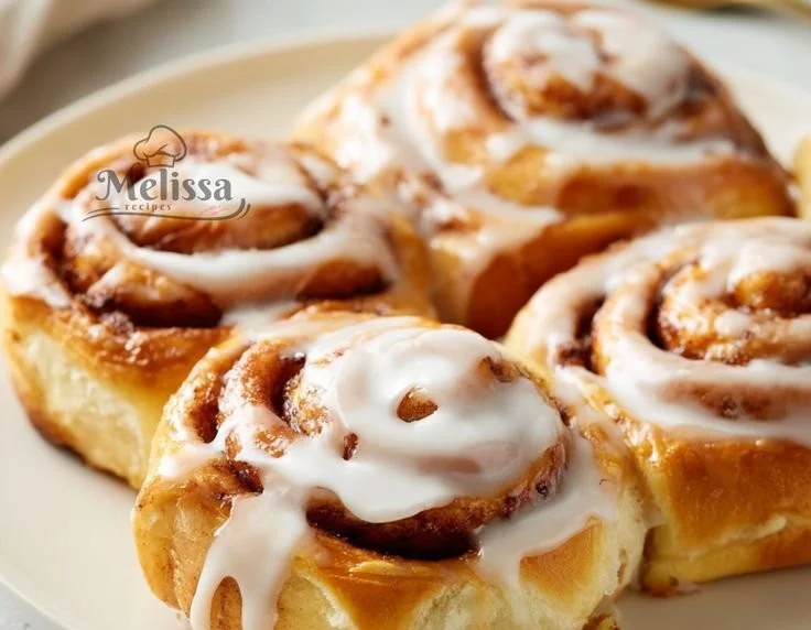 Delicious Greek Yogurt Cinnamon Rolls topped with icing on a plate.
