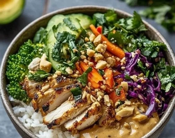 High-Protein Thai Peanut Chicken Bowl with fresh vegetables and peanut sauce