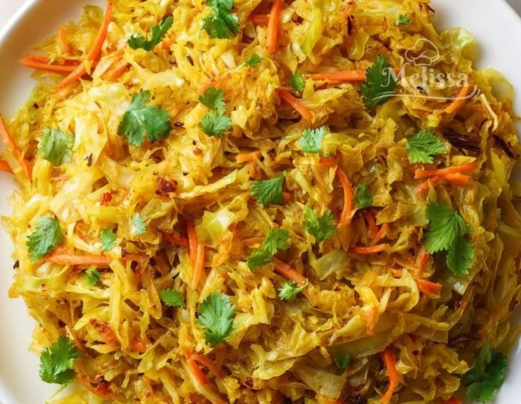 Delicious Indian cabbage dish garnished with spices and herbs.