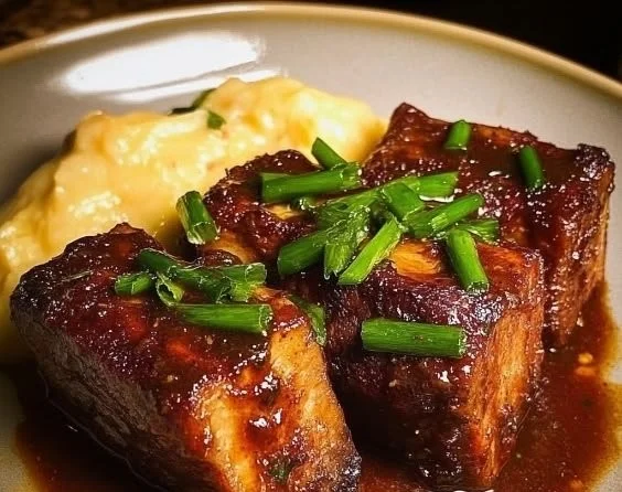 Delicious melt-in-your-mouth beef short ribs served with sides.
