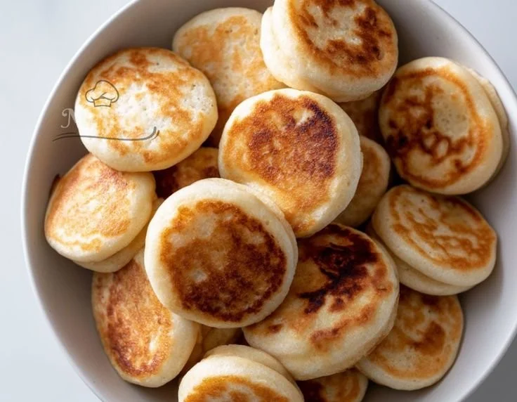 Delicious pancake poppers served with syrup and berries