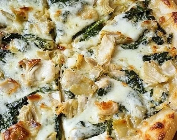 Delicious Spinach Artichoke Pizza topped with creamy spinach and artichokes