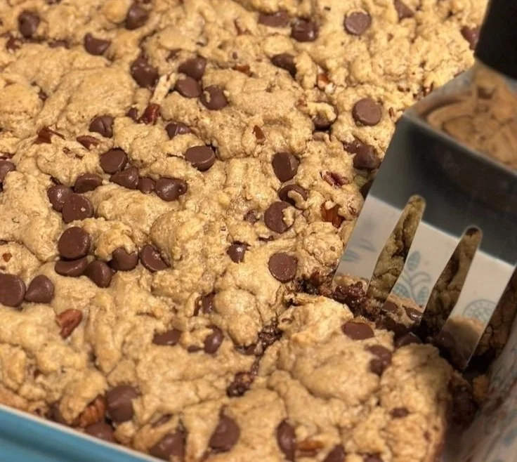 Delicious blondies with caramel drizzle and chocolate chips on a plate.