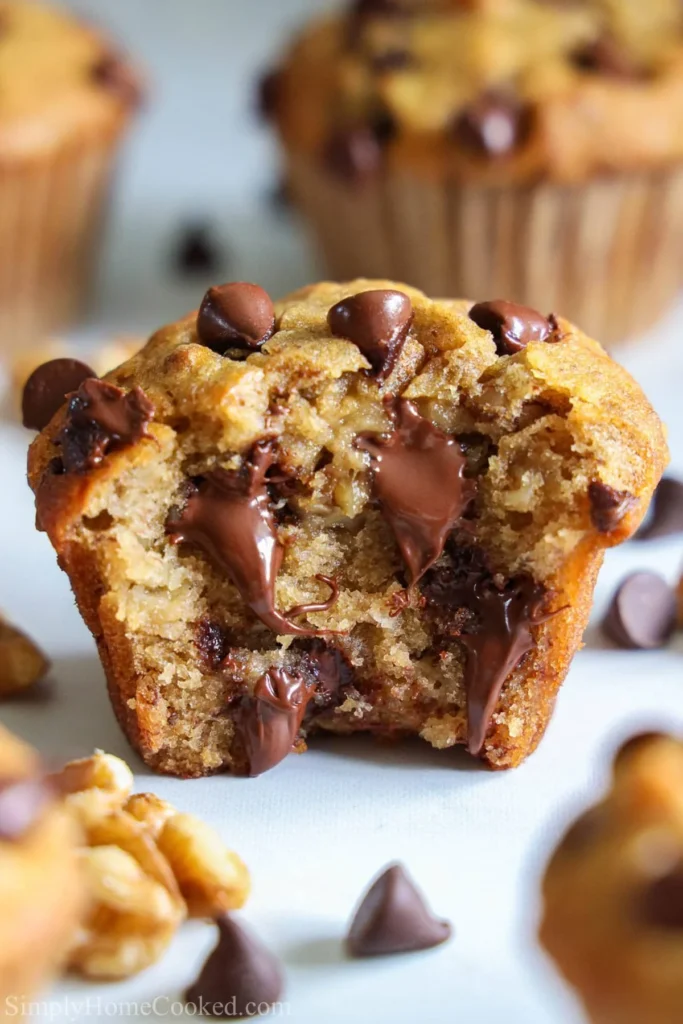 Freshly baked banana chocolate chip muffins on a cooling rack