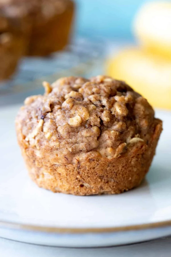 Freshly baked banana oatmeal muffins on a wooden table