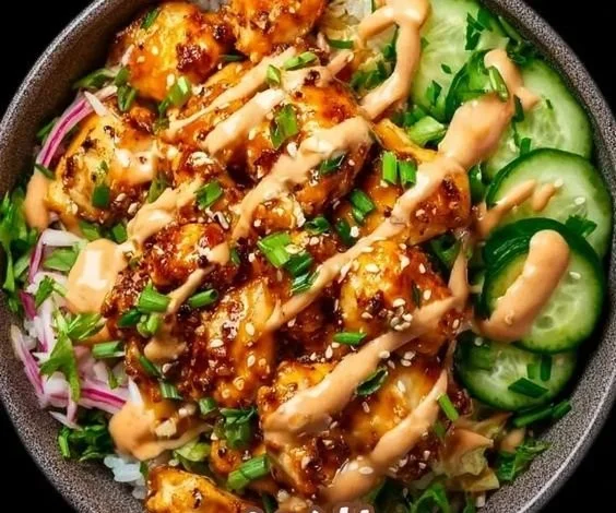 Delicious Bang Bang Chicken Bowl with vibrant vegetables and spicy sauce