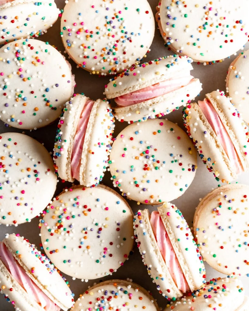 Colorful birthday cake macarons arranged on a festive table