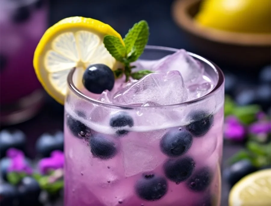 Glass of Blueberry Lavender Lemonade with fresh blueberries and lavender sprigs