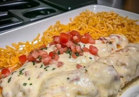 Delicious cheese chicken enchiladas topped with melted cheese and fresh herbs