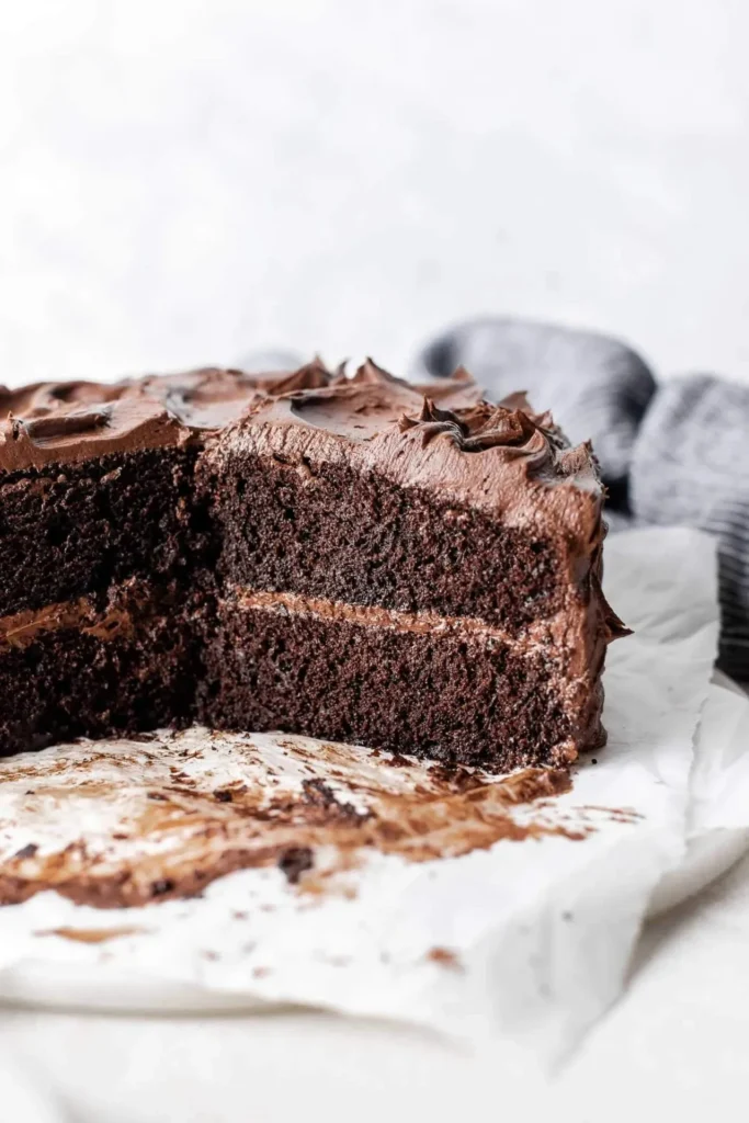 Decadent homemade chocolate cake topped with rich chocolate frosting.