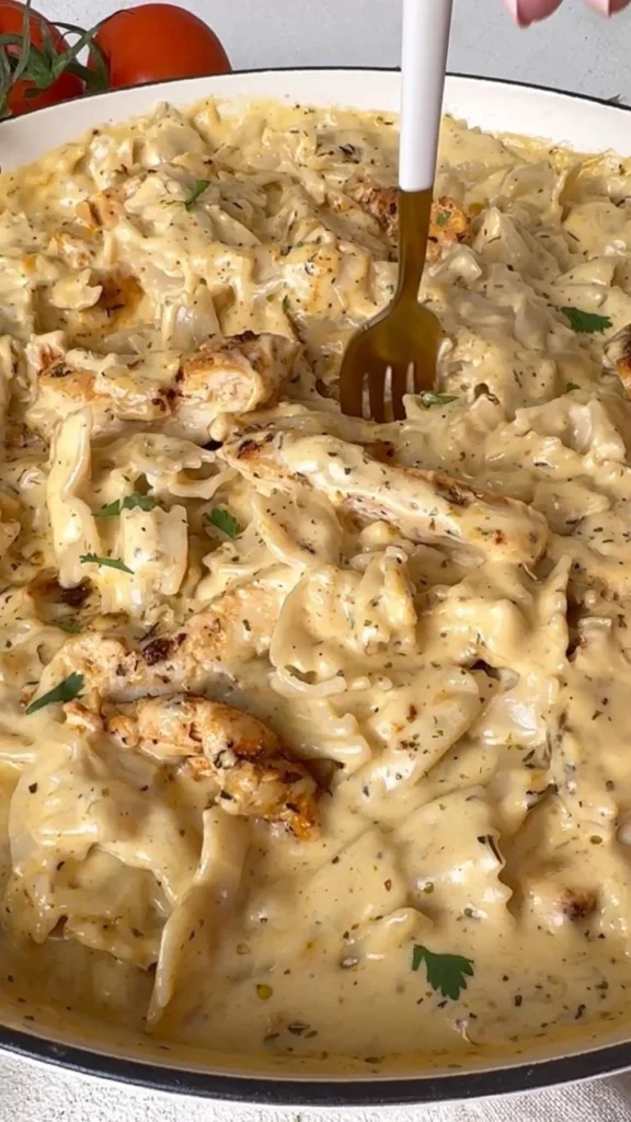 Plate of creamy Chicken Alfredo with pasta and grilled chicken slices