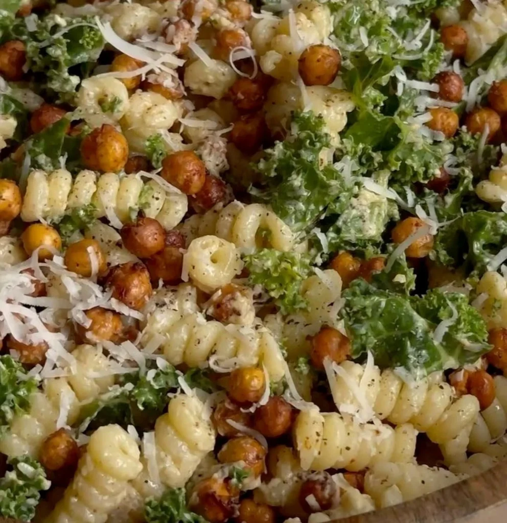 A vibrant bowl of delicious Pasta Caesar Salad with crispy croutons and parmesan