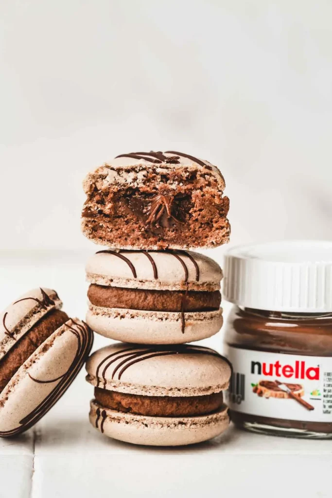 Easy chocolate macarons with Nutella filling on a plate