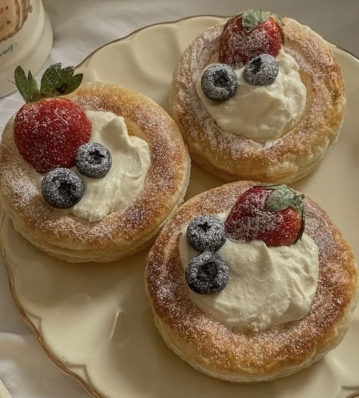 Easy puff pastry dessert topped with cream and berries