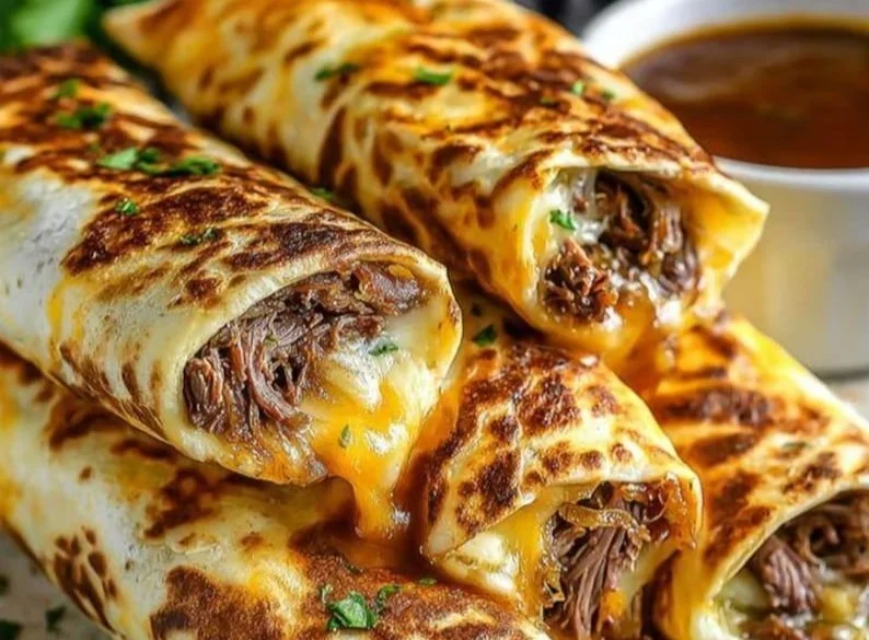 French Dip Tortilla Roll Ups served on a platter