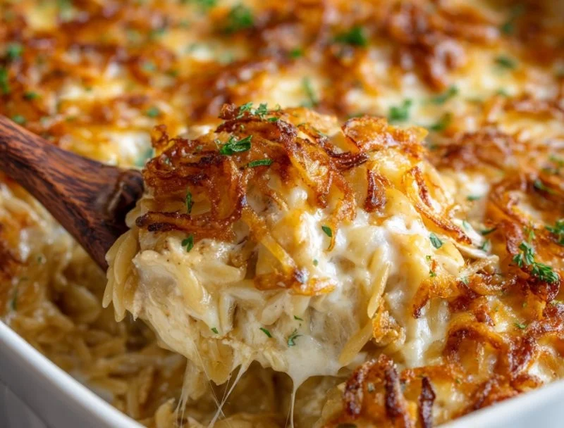 French onion chicken orzo casserole topped with melted cheese
