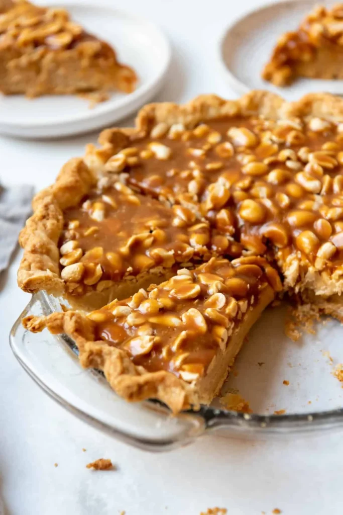 Delicious homemade Payday Pie with caramel, peanuts, and chocolate layers.