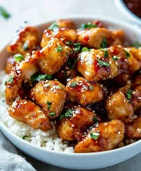 Delicious plate of Honey Garlic Chicken garnished with herbs