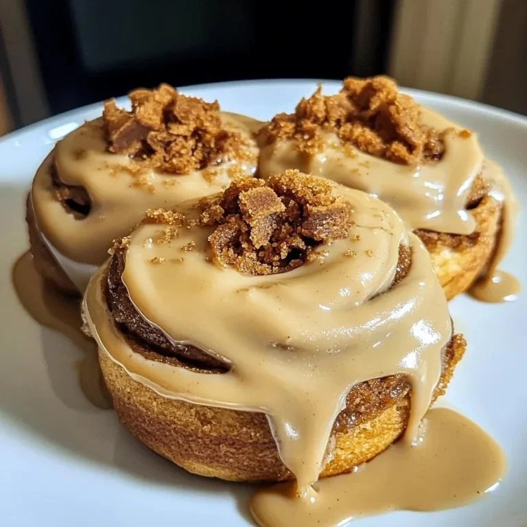 Fluffy Biscoff cookie butter cinnamon rolls with icing and cinnamon topping