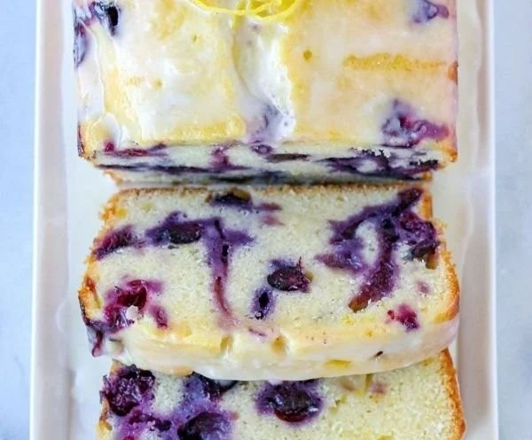 Freshly baked Lemon Blueberry Bread with a golden crust and vibrant blueberries.