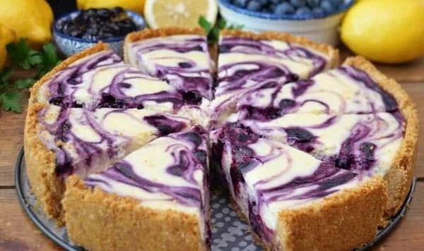 Deliciously layered lemon blueberry cheesecake with fresh blueberries