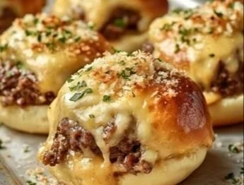 Mini Big Mac cheeseburgers served on a plate with fresh ingredients.