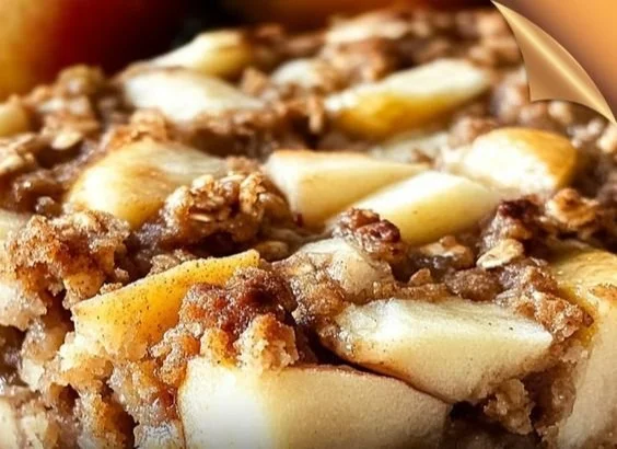 Oatmeal apple breakfast bake topped with fresh slices of apple and cinnamon.