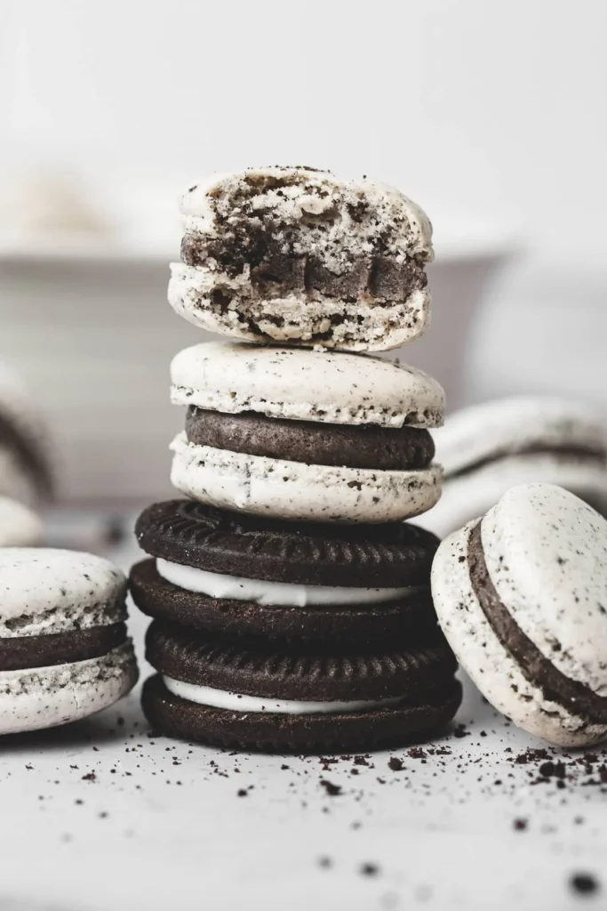 Oreo macarons filled with cream and topped with crushed Oreo cookies