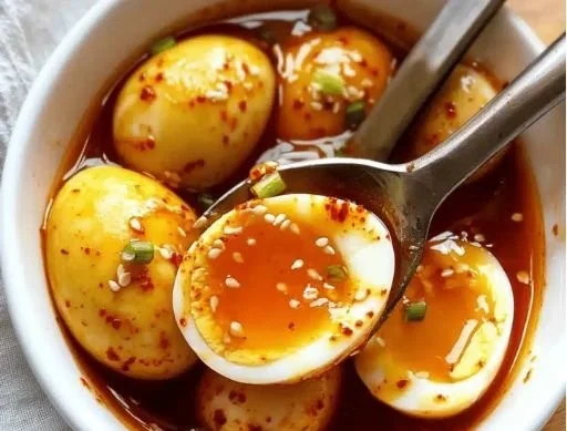 Spicy Gochujang Eggs served in a bowl with garnishes