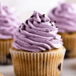Delicious blueberry cupcakes topped with honey in a rustic setting