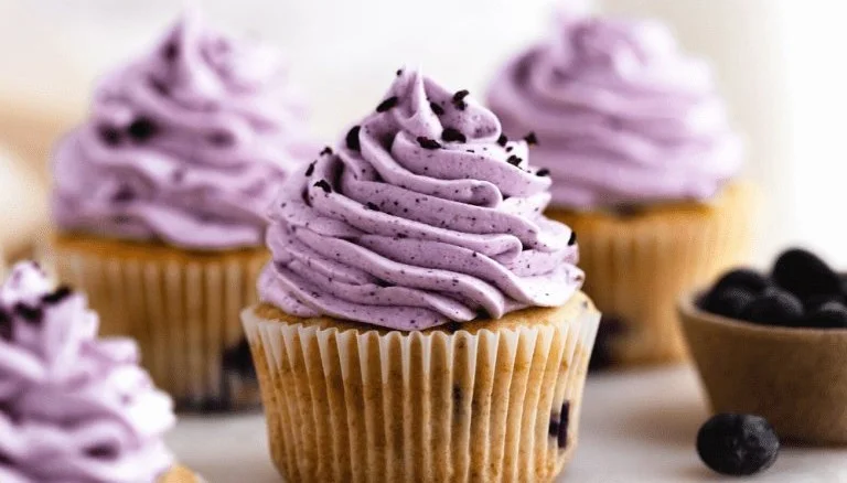 Delicious blueberry cupcakes topped with honey in a rustic setting