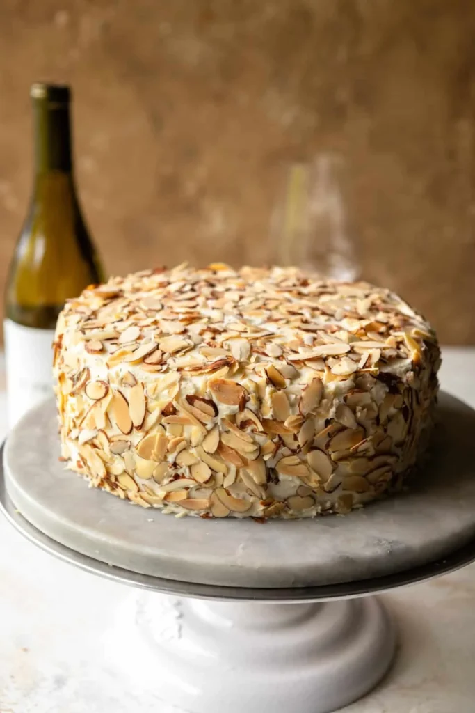 Delicious toasted almond cream cake topped with creamy frosting and toasted almonds
