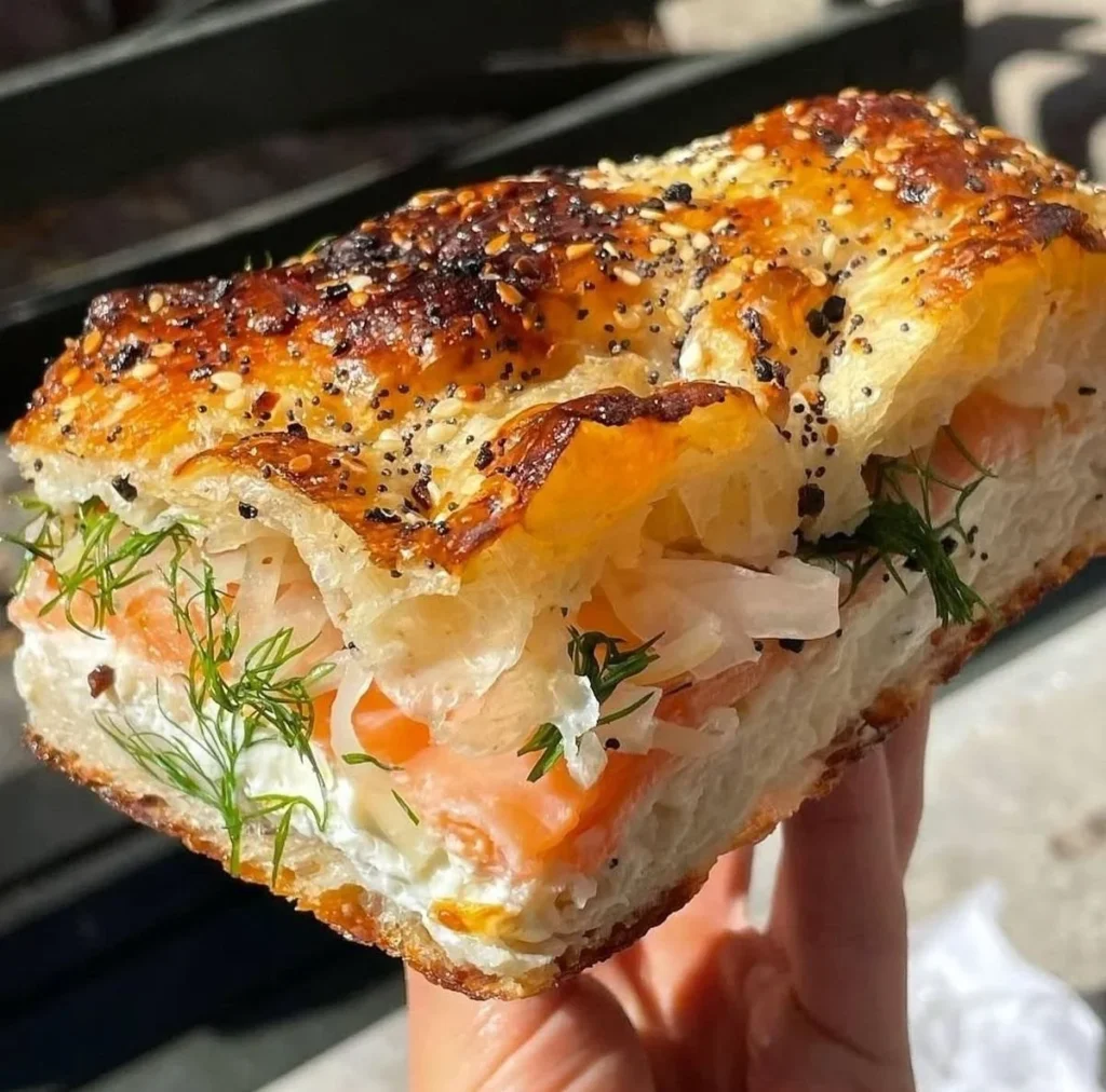 Viral smoked salmon cream cheese stuffed bread topped with fresh herbs