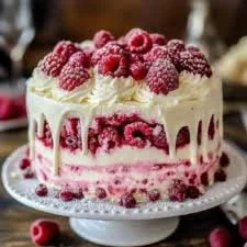 Slice of White Chocolate Raspberry Cake with fresh raspberries on top