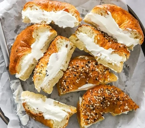 Delicious air fryer protein bagels on a wooden board garnished with seeds.