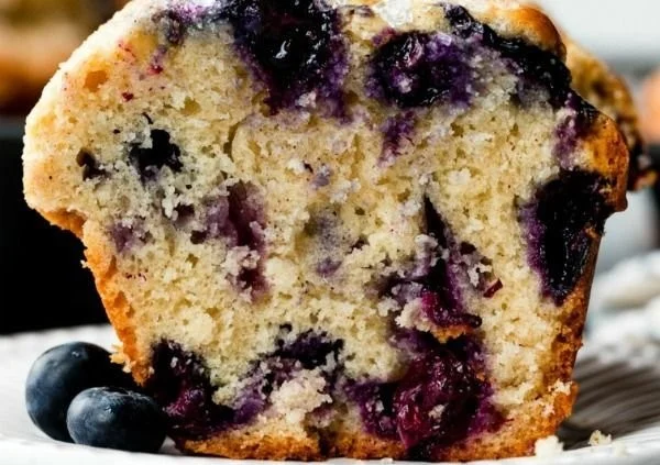 Delicious bakery-style blueberry muffins with fresh blueberries and a golden top.