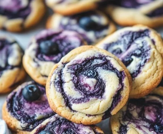Delicious blueberry cheesecake cookies topped with fresh blueberries