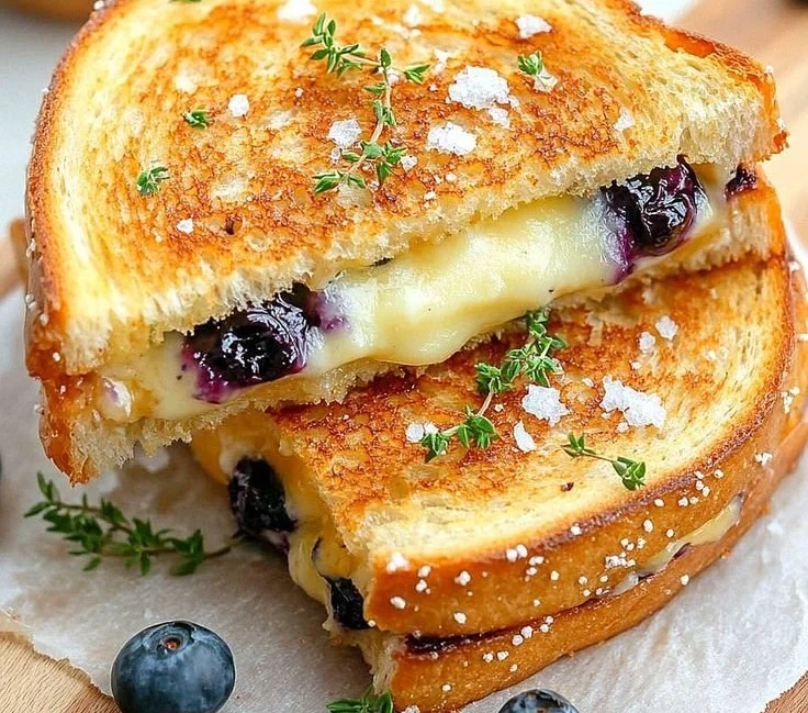 Blueberry grilled cheese sandwich with melted cheese and fresh blueberries
