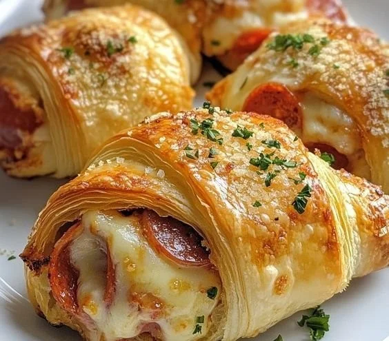 Delicious cheesy pepperoni mozzarella croissant rolls served on a plate.