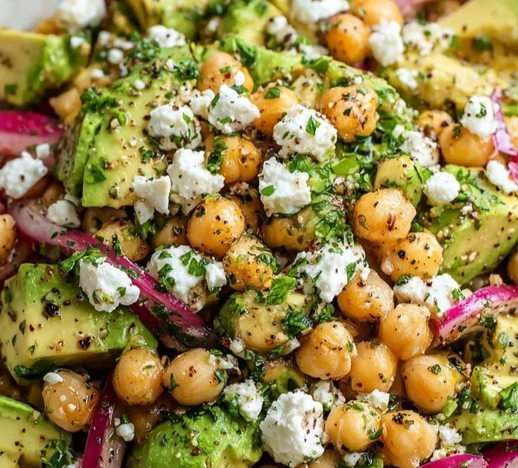 Chickpea feta avocado salad in a bowl with vibrant vegetables