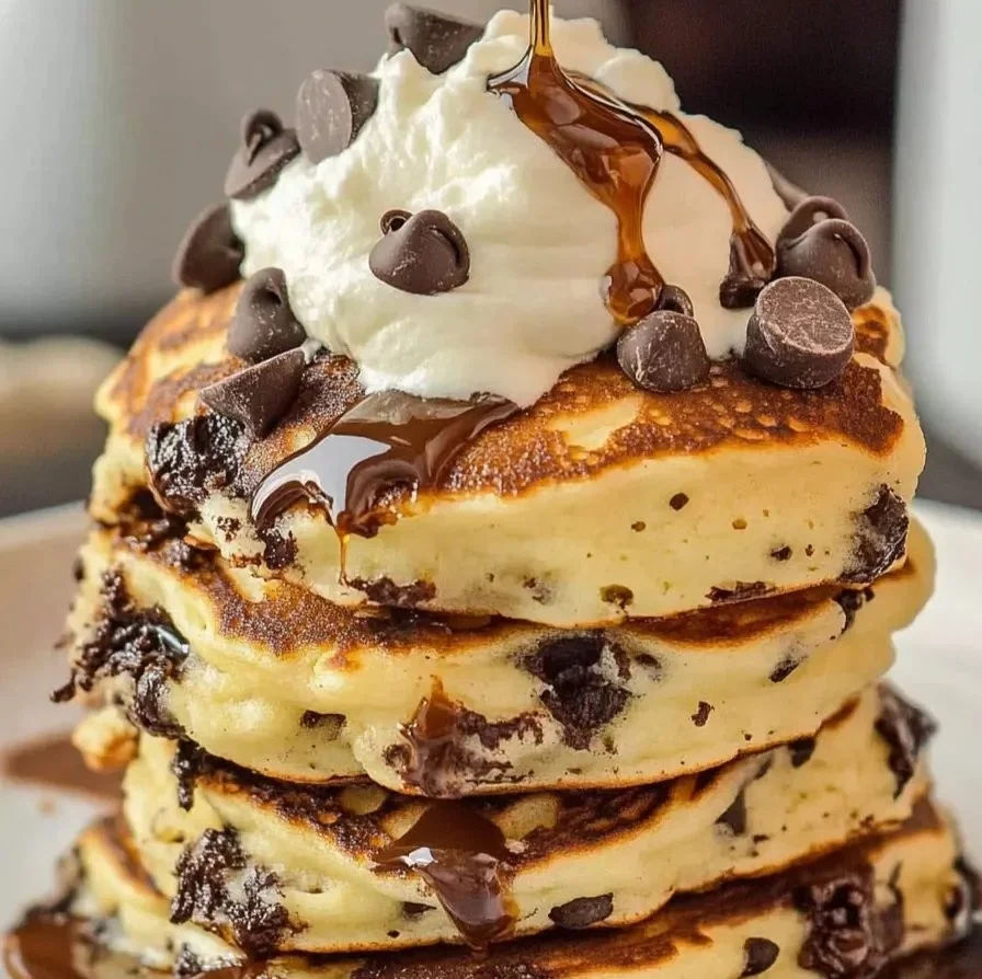 Delicious chocolate chip pancakes stacked with a drizzle of syrup