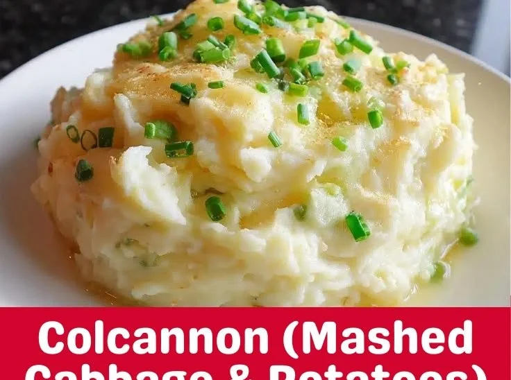 A bowl of creamy colcannon made with potatoes and cabbage served on a table.